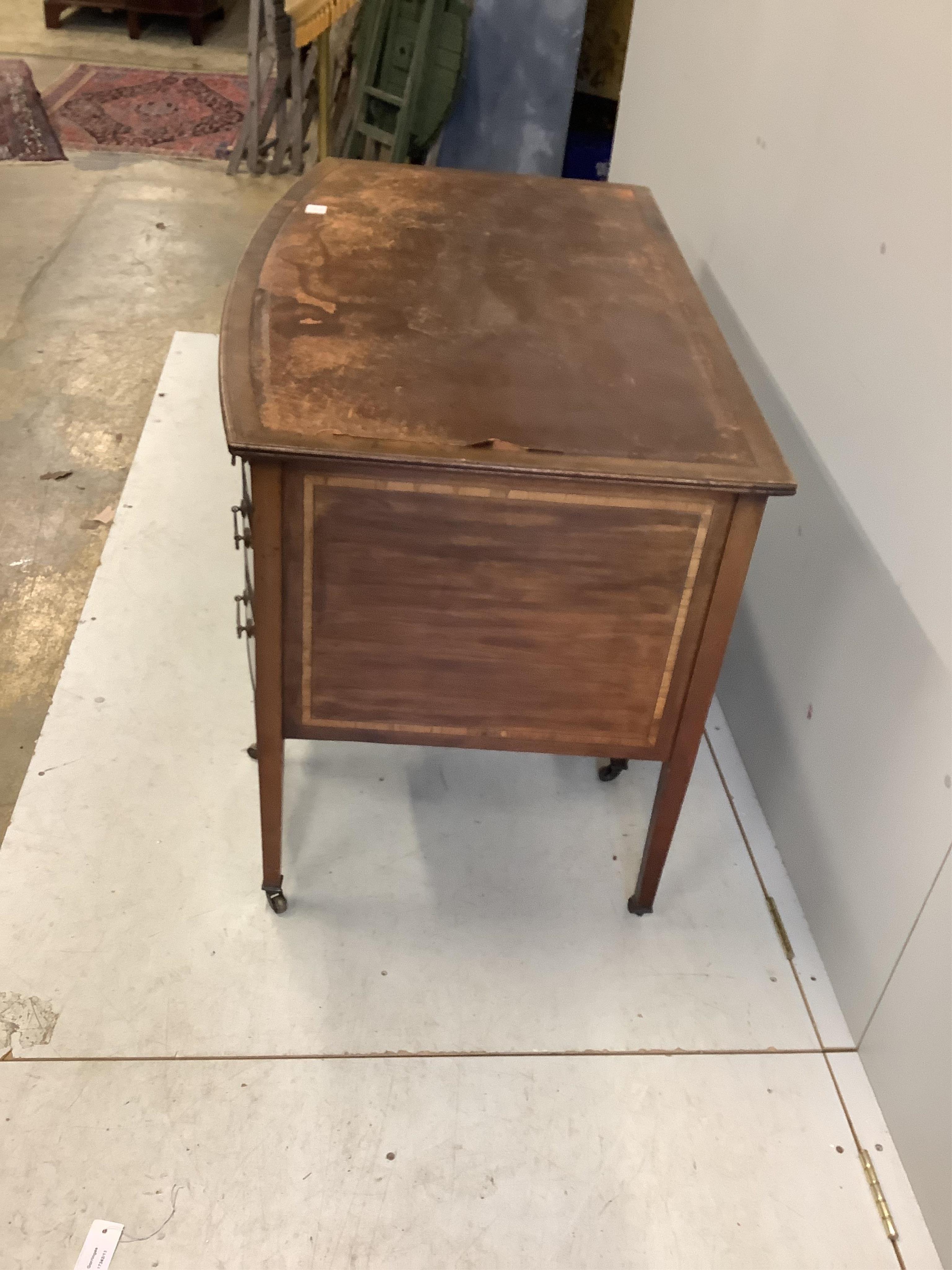 An Edwardian mahogany bowfront kneehole writing table, width 122cm, depth 70cm, height 76cm. Condition - fair